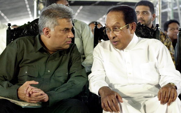 COLOMBO, SRI LANKA: Sri Lanka's Prime Minister Ranil Wickremesinghe(L) listens as Ronnie de Mel (R), a former minister in President Chandrika KUmaratunga's party who defected to the premier's party at a meeting in Colombo, 22 February 2004. Wickremesinghe launched his election campaign for the 02 April 2004 snap parliamentary vote seeking support for his peace bid with Tamil Tiger rebels. AFP PHOTO (Photo credit should read STR/AFP/Getty Images)