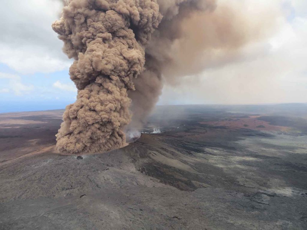 This Friday, May 4, 2018, aerial image released by the U.S. Geological Survey, at 12:46 p.m. HST, a column of robust, reddish-brown ash plume occurred after a magnitude 6.9 South Flank of Kīlauea earthquake shook the Big Island of Hawaii, Hawaii. The Kilauea volcano sent more lava into Hawaii communities Friday, a day after forcing more than 1,500 people to flee from their mountainside homes, and authorities detected high levels of sulfur gas that could threaten the elderly and people with breathing problems. (U.S. Geological Survey via AP)