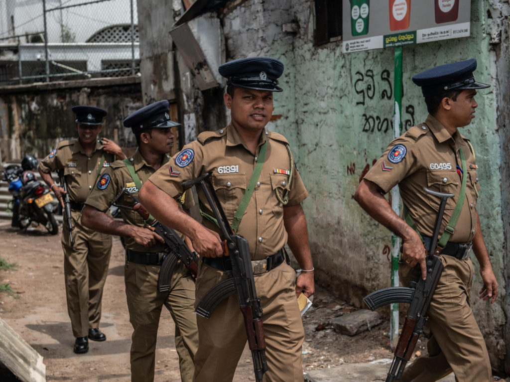 ජාඇල සහ වත්තලටත් පොලිස් ඇඳිරි නීතිය-පුත්තලමට පැනවූ ඇදිරි නීතිය තවදුරටත් 1 Police officers patrol the area around Dawatagaha mosque ahead of prayers on Friday in Colombo, Sri Lank