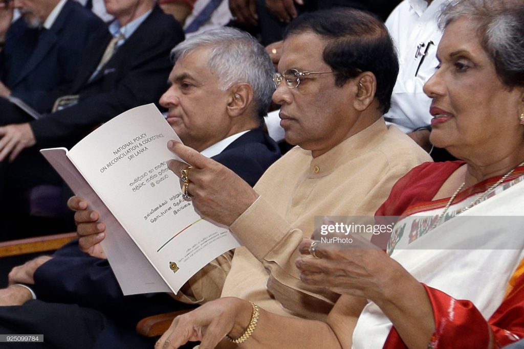 Sri Lankan president Maithripala Sirisena reads the National policy on 'Reconciliation and Co-existence' after it was officially launched as Sri Lanka's prime minister Ranil Wickramasinghe (L) and former president Chandrika Kumaratunga (3L) look on at Colombo, Sri Lanka on Tuesday 27 February 2018. (Photo by Tharaka Basnayaka/NurPhoto via Getty Images)