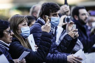 Faithful wear protective face masks as they wait for the arrival of Pope Francis to the Basilica of Santa Sabina before the Ash Wednesday mass, Rome, 26 February 2020. ANSA/FABIO FRUSTACI